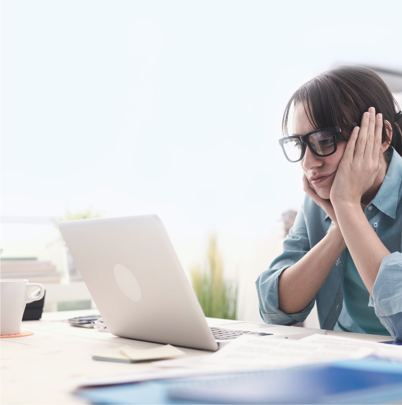 photo of a woman staring at a computer on an office desk